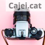 Black and Silver Camera on Brown Wooden Table